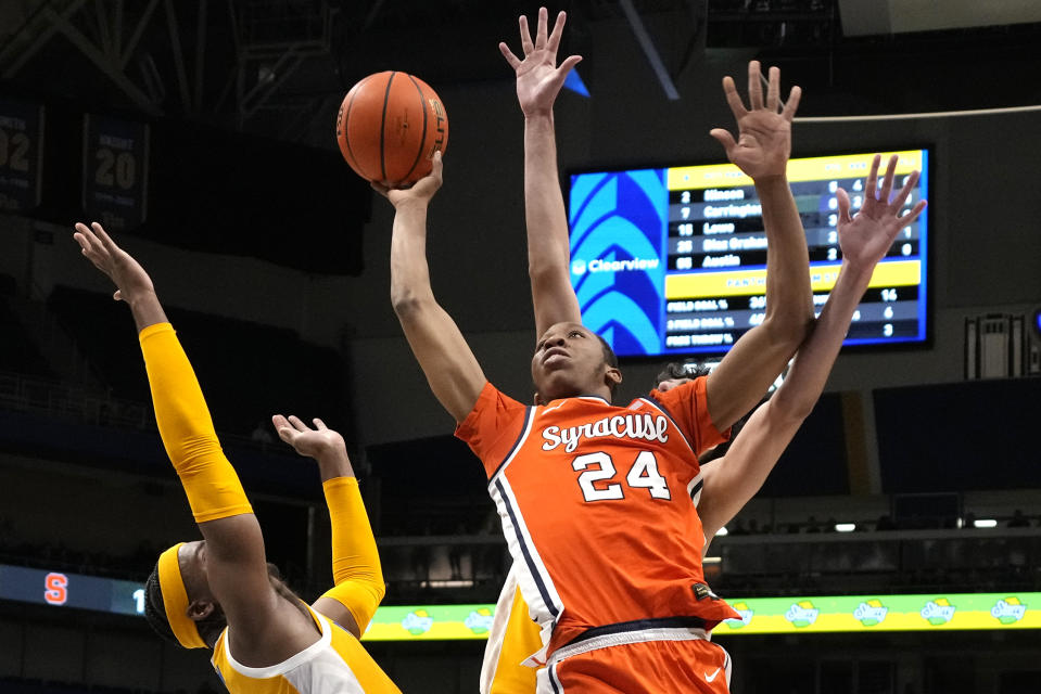 Syracuse's Quadir Copeland (24) shoots over Pittsburgh's Blake Hinson, left, during the first half of an NCAA college basketball game in Pittsburgh on Tuesday, Jan. 16, 2024. (AP Photo/Gene J. Puskar)