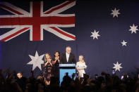 Australian Prime Minister Scott Morrison, second right, arrives on stage to speak to party supporters flanked by his wife, Jenny, and daughters Lily, and Abbey, left, after his opponent concedes defeat in the federal election in Sydney, Australia, Sunday, May 19, 2019. Australia's ruling conservative coalition, lead by Morrison, won a surprise victory in the country's general election, defying opinion polls that had tipped the center-left opposition party to oust it from power and promising an end to the revolving door of national leaders. (AP Photo/Rick Rycroft)