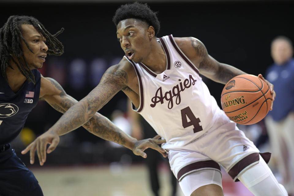 Texas A&M guard Wade Taylor IV (4) drives against Penn State guard Ace Baldwin Jr., left, during the first half of an NCAA college basketball game, Thursday, Nov. 23, 2023, in Kissimmee, Fla. (AP Photo/Phelan M. Ebenhack)