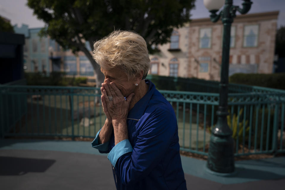 Yvonne Ansdell, mother of Allan Ansdell Jr, owner and president of Adventure City amusement park, is overcome with emotion as her son brings out a "Welcome Back" sign ahead of its reopening in Anaheim, Calif., Wednesday, April 14, 2021. The family-run amusement park that had been shut since March last year because of the coronavirus pandemic reopened on April 16. "I consider it a real blessing," Ansdell said about the reopening. "Our life is truly a roller coaster. Ups and downs, but you have to learn how to wade through the downs so you can get the highs." (AP Photo/Jae C. Hong)