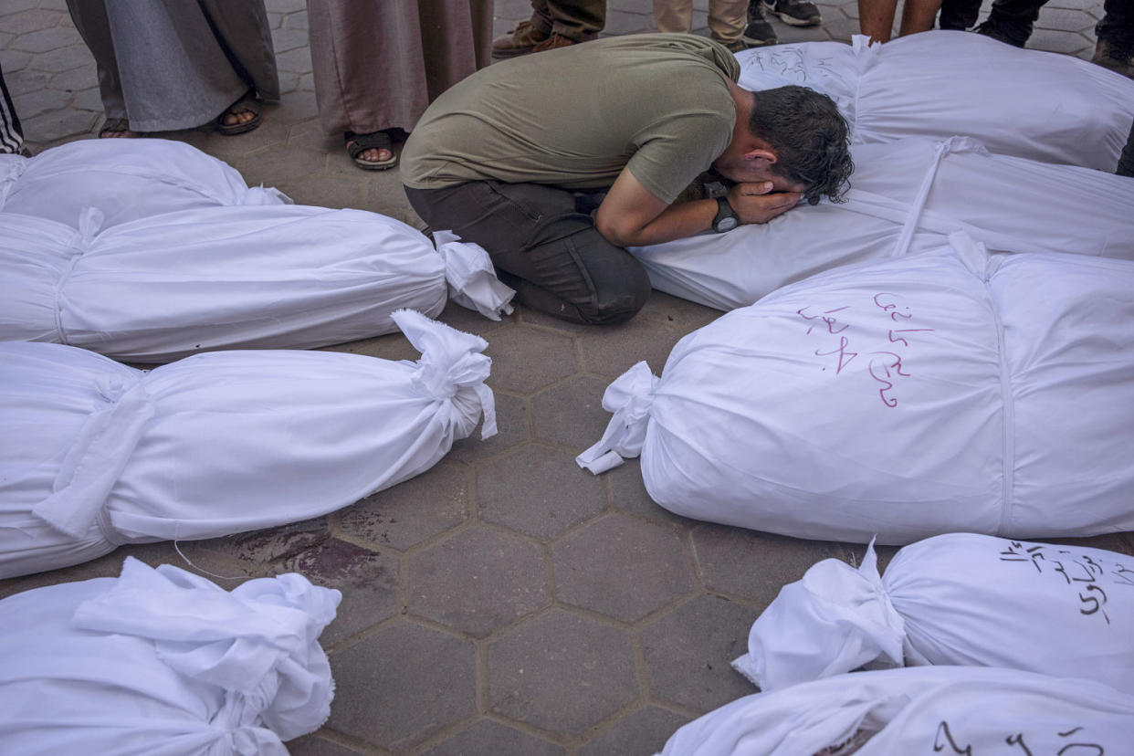 Palestinians mourn relatives at the morgue in Deir al Balah, Gaza, on Tuesday, Oct. 31, 2023. (Fatima Shbair / AP)