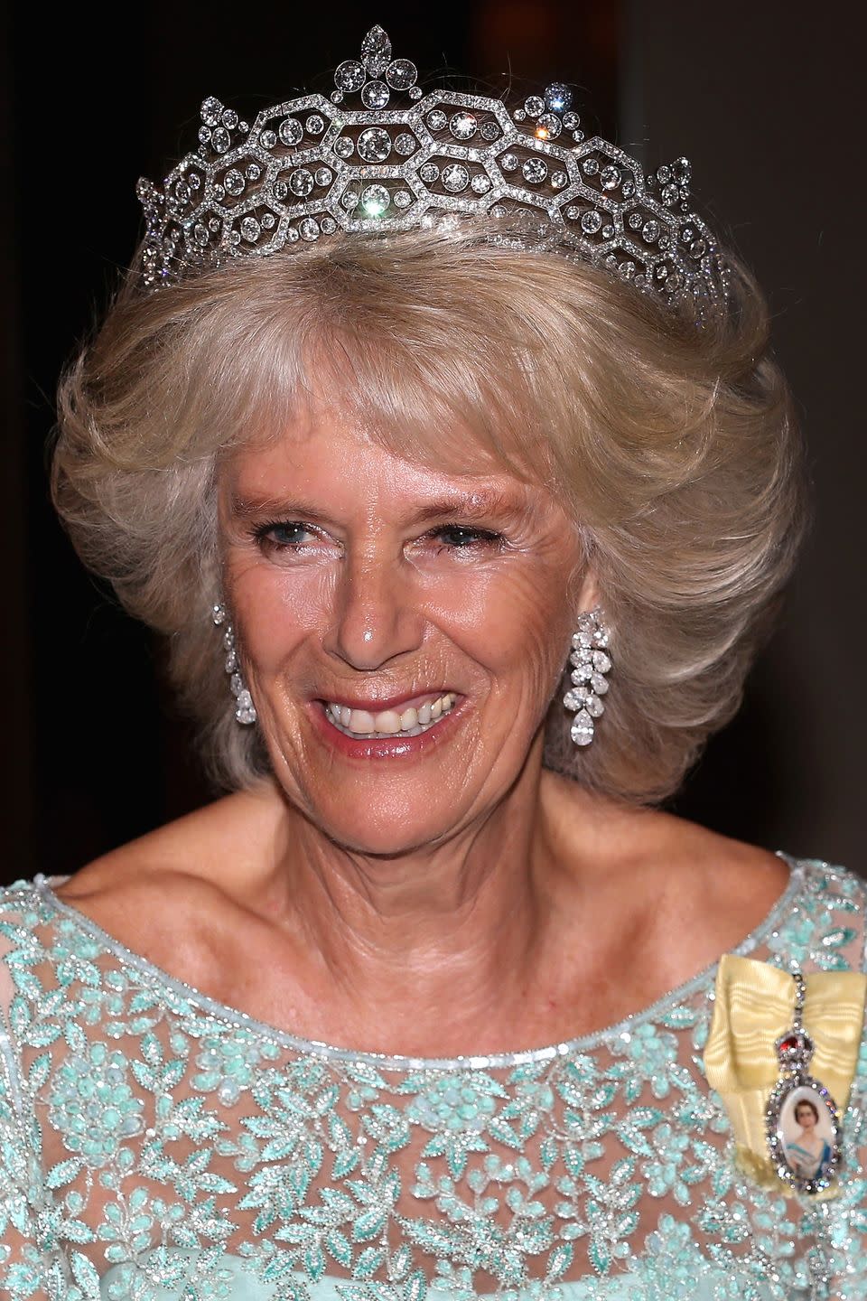 <p>The Greville tiara was made by Boucheron for Dame Margaret Helen Greville in 1920. It is also known as the Boucheron Honeycomb tiara, and is worn here by Camilla, Duchess of Cornwall. Greville left the tiara to the Queen Mother when she died in 1942, and upon the death of the Queen Mother in 2002, the Queen inherited the headpiece. It is now one of three tiaras on long-term loan to Camilla, who married Prince Charles in 2005. </p>