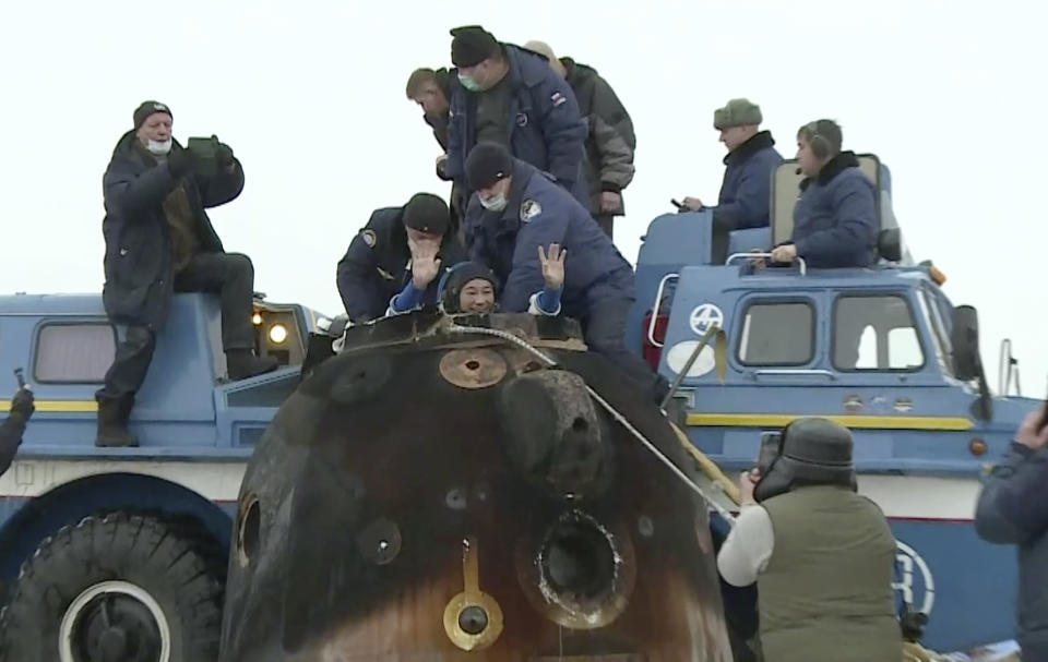 In this photo taken from video footage released by the Roscosmos Space Agency, Russian space agency rescue team help spaceflight participant Yusaku Maezawa to get from the capsule shortly after the landing of the Russian Soyuz MS-20 space capsule about 150 km ( 80 miles) south-east of the Kazakh town of Zhezkazgan, Kazakhstan, Monday, Dec. 20, 2021. A Japanese billionaire, his producer and a Russian cosmonaut safely returned to Earth on Monday after spending 12 days on the International Space Station. (Roscosmos Space Agency via AP)