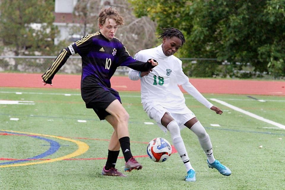 Fort Collins' Maxwell Dirvonas, left, battles with Fossil Ridge mid-fielder Njoroge Kimani during a high school soccer match at Fort Collins High School on Thursday, Oct. 12, 2023.