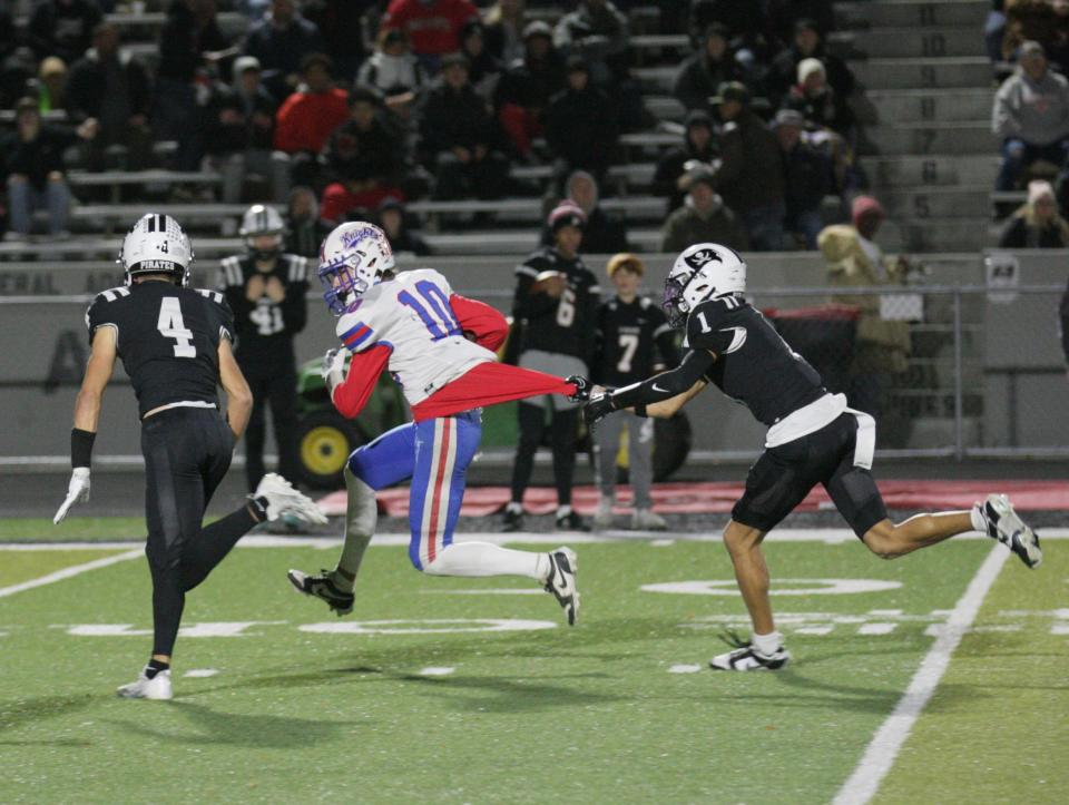 Perkins defender Braylon Collier grabs Kyle Maltarich's shorts and slows the receiver down.