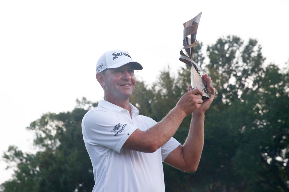 PGA Tour player Lucas Glover poses for a portrait with the FedEx St. Jude Championship trophy after winning the event in a playoff against Patrick Cantlay on the eighteenth hole at TPC Southwind in Memphis, Tenn., on Sunday, August 13, 2023.