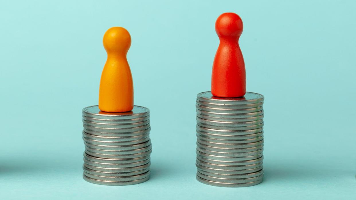 two figures on stacks of coins