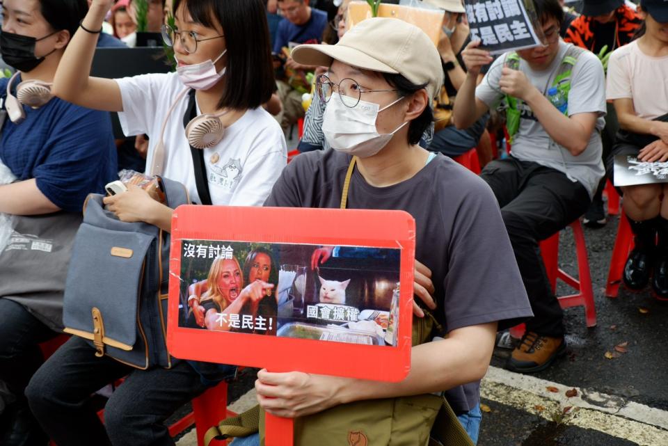 多個民團集結在立法院外，抗議院會續審國會改革法案，參與民眾手舉不同標語。陳祖傑攝