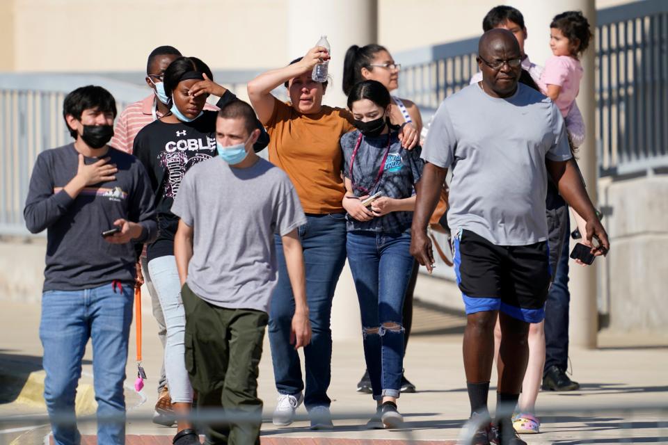 Families depart a performing arts center Wednesday in Mansfield, Texas, after being united with students from Timberview High School. Police in Texas arrested a student suspected of opening fire during a fight at the Arlington-area high school, leaving four people injured.