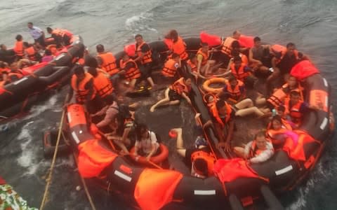 Rescued tourists are seen on life rafts near the island of Phuket - Credit: Xinhua/Barcroft Images 