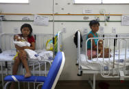 Yanomami women hold their babies receiving medical treatment at the Santo Antonio Children's Hospital, in Boa Vista, Roraima state, Brazil, Thursday, Jan 26, 2023. Brazil's government declared a public health emergency for the Yanomami people in the Amazon, who are suffering from malnutrition and diseases such as malaria. (AP Photo/Edmar Barros)