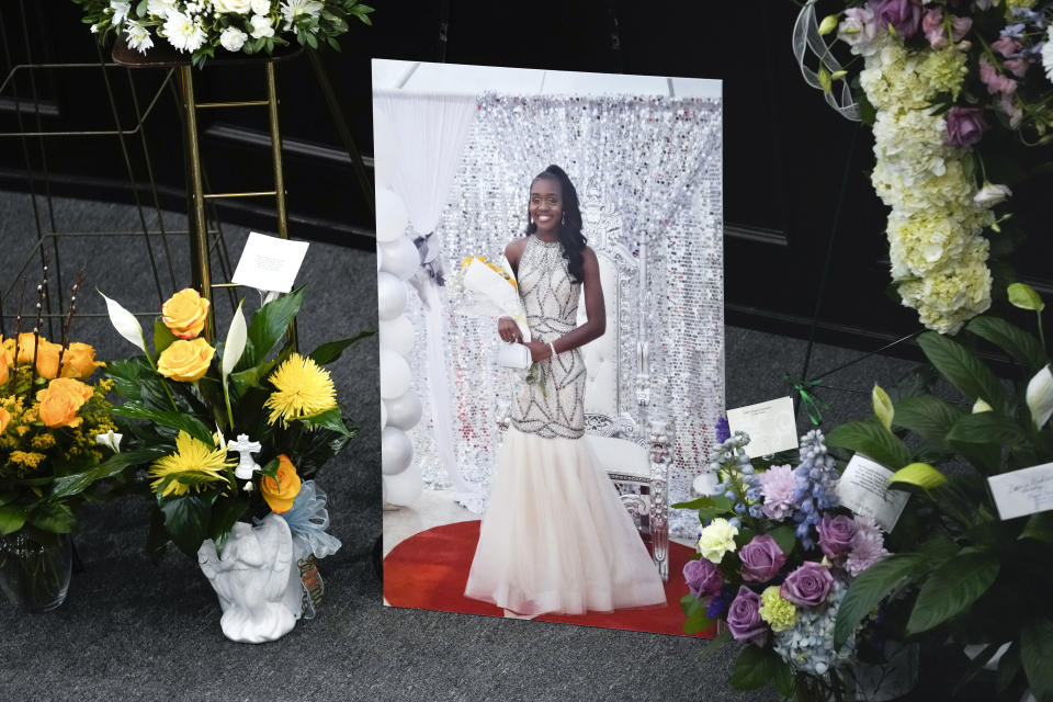 Flowers are shown near a photo of Michigan State University shooting victim Arielle Anderson at a funeral in Detroit, Tuesday, Feb. 21, 2023. Anderson, Alexandria Verner and Brian Fraser and were killed and several other students injured after a gunman opened fire on the campus of Michigan State University. (AP Photo/Paul Sancya)