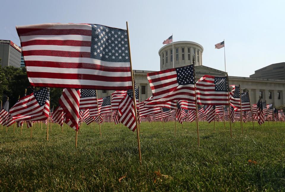 American flags on display on the west lawn of the Ohio Statehouse in 2013. The flags, planted in the shape of the World Trade Center with the Pentagon notched out in the middle, honored those who were killed in the 9/11 terrorist attacks.