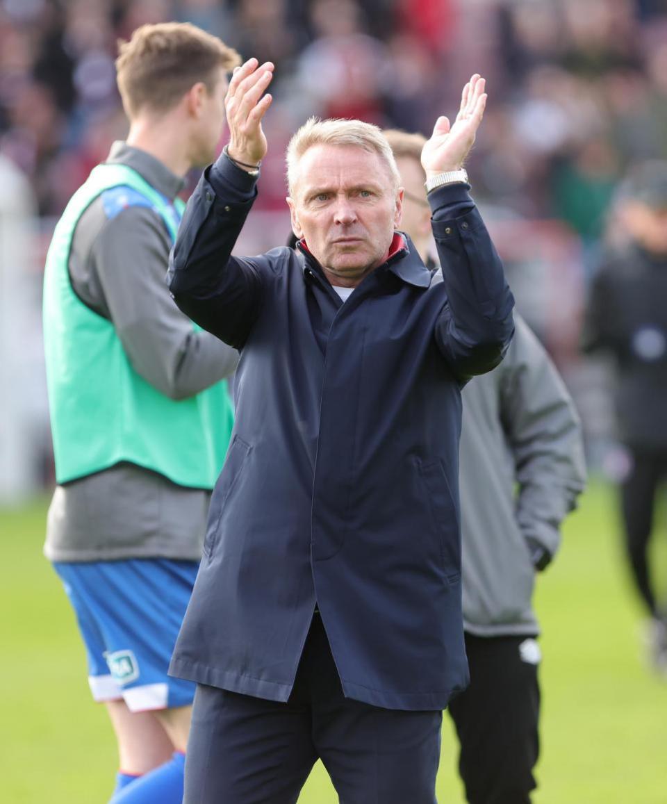 News and Star: Paul Simpson applauds United's fans at Northampton