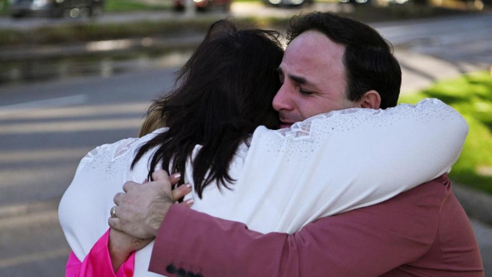 PHOTO: Carlos Gonzalez, a worship singer, hugs a fellow churchgoer after a shooting incident at television evangelist Joel Osteen's Lakewood Church in Houston, Texas, Feb.11, 2024. (Callaghan O'hare/Reuters)