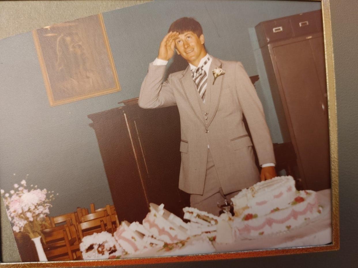 Randy McCune, then 20, stands behind the cake that collapsed on his wedding day May 29, 1982 in Newcomertown. The late Rod Smith, of Rod's Donut Shop in Uhrichsville, replaced the cake before the reception started.