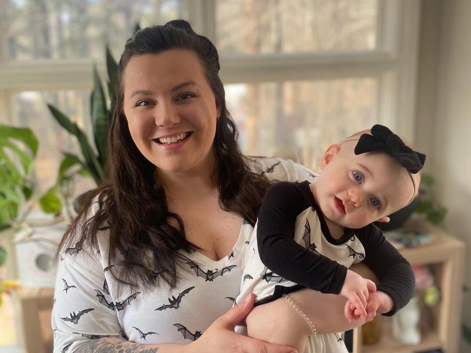 Mom-of-one Jessyca O'Brien, who is struggling during the formula crisis, holds her one-year-old daughter, Luna, at their home in Maine.