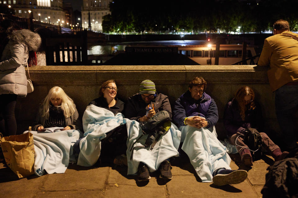 LONDON, ENGLAND - SEPTEMBER 19: People rest during a pause in movement as the last stretch of a days-long queue passes along the South Bank on September 19, 2022 in London, United Kingdom. Elizabeth Alexandra Mary Windsor was born in Bruton Street, Mayfair, London on 21 April 1926. She married Prince Philip in 1947 and acceded to the throne of the United Kingdom and Commonwealth on 6 February 1952 after the death of her Father, King George VI. Queen Elizabeth II died at Balmoral Castle in Scotland on September 8, 2022, and is succeeded by her eldest son, King Charles III. (Photo by Alex McBride/Getty Images)