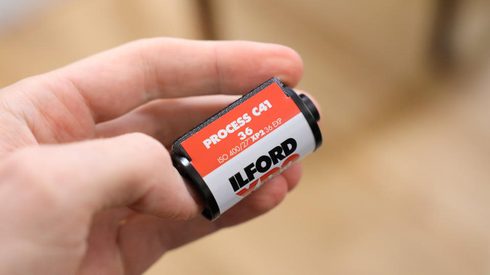 Ilford XP2 Super 35mm film canister held in a hand