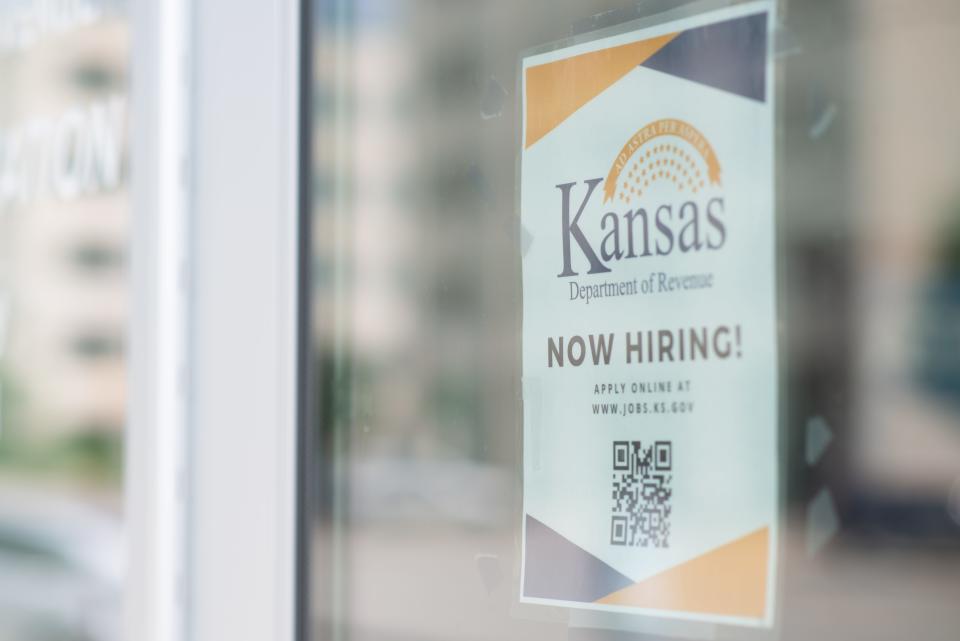 "Now hiring" signs are seen on the entrance to the Kansas Department of Revenue offices. According to the Greater Topeka Partnership, there are about 250 active job listings in Shawnee County with average wages increased by 3.5%.