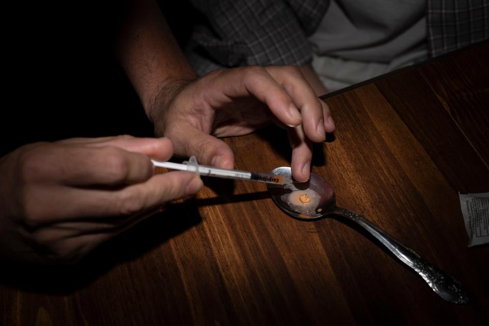 Addicts break down suboxone, a drug commonly used to curb opioid addiction, in preparation for injecting the drug to get high in Austin, Indiana. Oct. 19, 2018
