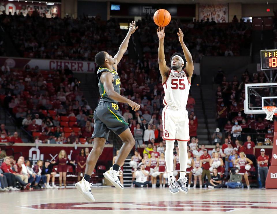 Oklahoma's Elijah Harkless (55) shoots a 3-point basket as Baylor's Kendall Brown (2) defends in the second half  during the men's college game between the Oklahoma Sooners and the Baylor Bears at the Lloyd Noble Center in Norman, Okla., Saturday, Jan. 22, 2022. 