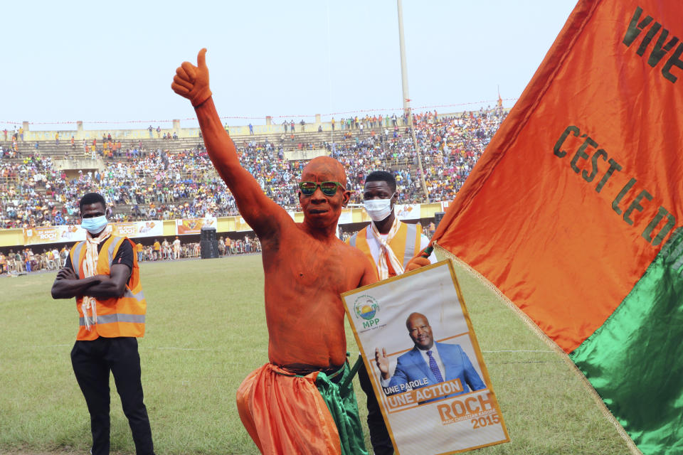 Supporters of Burkina Faso President Roch Kabore attend a campaign rally in Bobo-Dioulasso Thursday, Nov. 5, 2020. Burkina Faso will go to the polls on Nov. 22, 2020, to vote in presidential and legislative elections marred by ongoing violence. Attacks linked to Islamic militants have ravaged the once peaceful nation. (AP Photo/Sam Mednick)