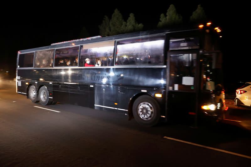 A bus carrying quarantined passengers from the Grand Princess cruise ship drives onto Travis Air Force Base in Fairfield