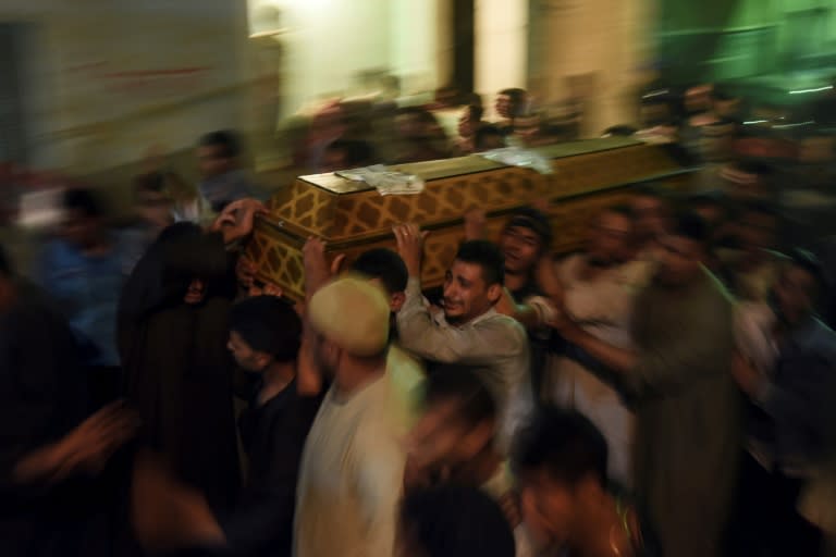 Relatives of the victims of an attack on Coptic Christians in Egypt's Minya province carry a coffin as they gather outside the Abu Garnous Cathedral in Maghagha, on May 26, 2017