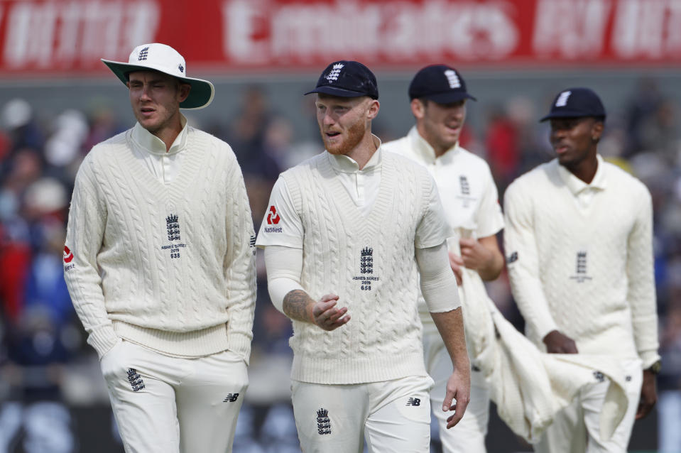 England's Stuart Broad, left, and Ben Stokes return to the pavilion for lunch break during day one of the fourth Ashes Test cricket match between England and Australia at Old Trafford in Manchester, England, Wednesday, Sept. 4, 2019. (AP Photo/Rui Vieira)