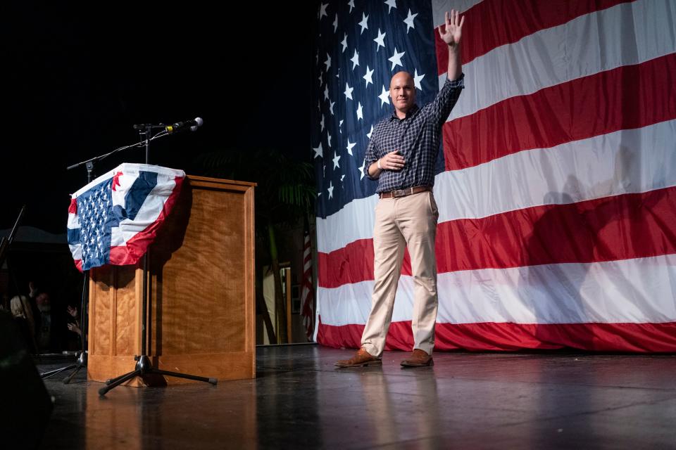J.D. Scholten, running for Congress in Iowa's Fourth Congressional District against Steve King in 2019, waves to supporters in Clear Lake, Iowa. 