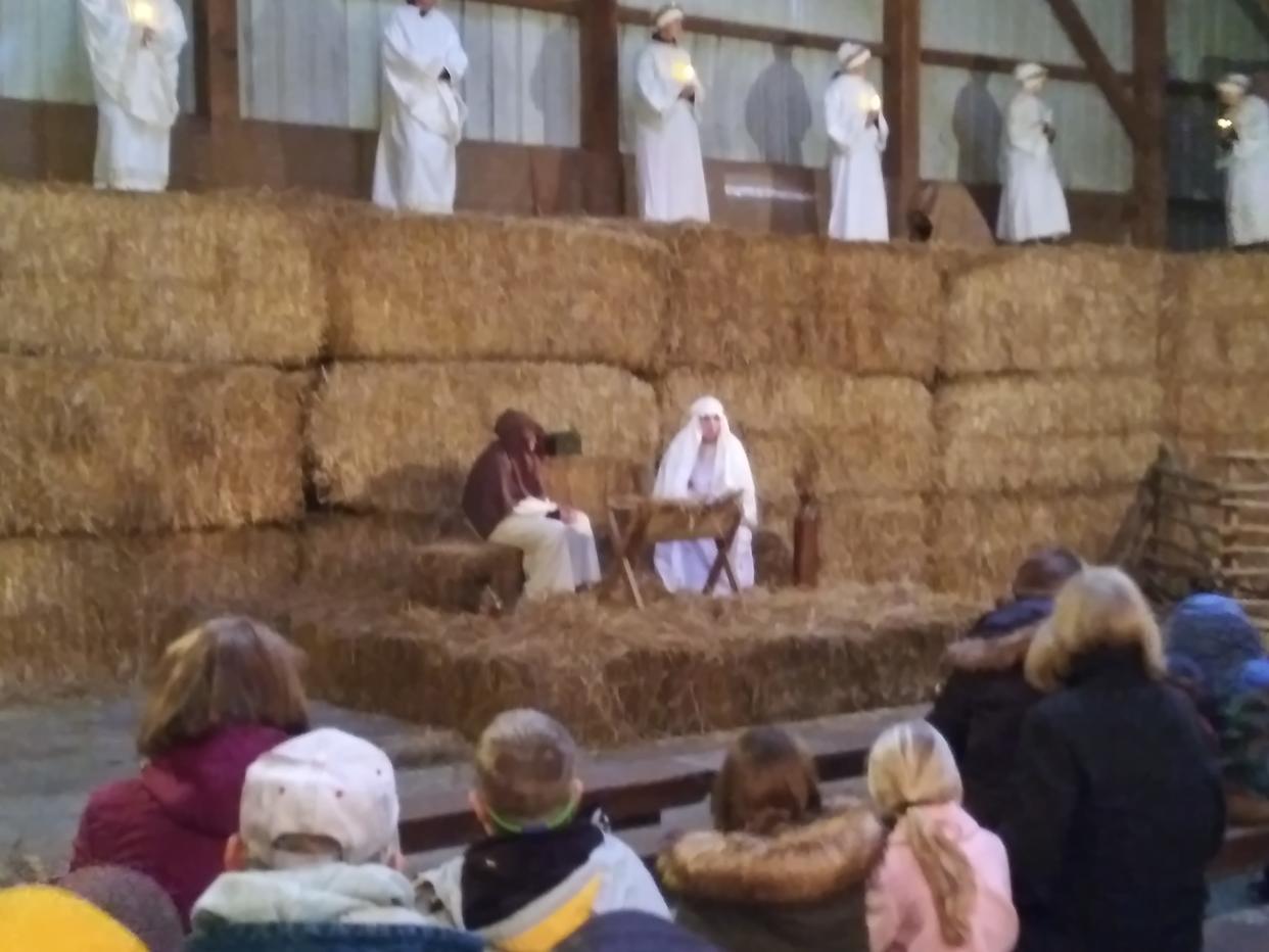 Visitors to the Farm at Walnut Creek on the Journey to Bethlehem enjoy angels singing over the manger scene where Mary and Joseph present the baby Jesus in this file photo.