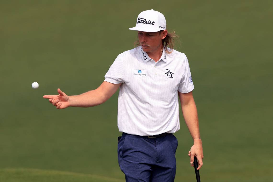 Cameron Smith of Australia handles his golf ball after putting on No. 2 during the first round of the Masters at Augusta National Golf Club, Thursday, April 7, 2022.