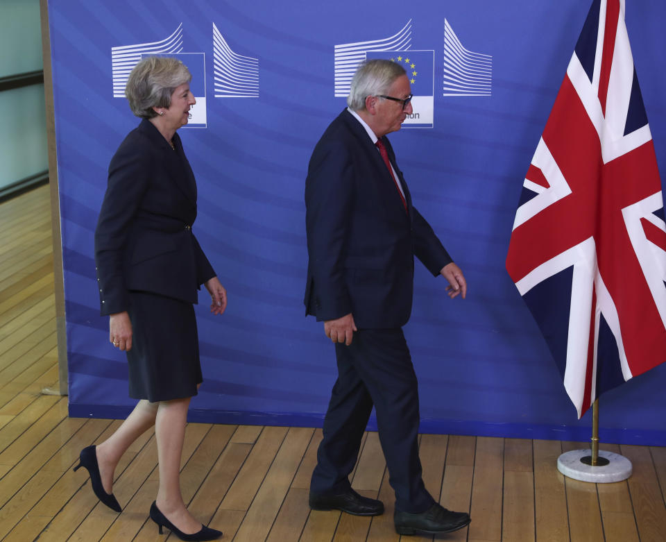 British Prime Minister Theresa May, left, and Jean-Claude Juncker, President of the European Commission, arrive for a photo opportunity as they meet in Brussels, Wednesday, Oct. 17, 2018 when European leaders meet to negotiate on terms of Britain's divorce from the European Union. (AP Photo/Francisco Seco)