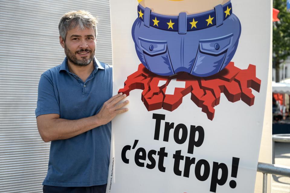 Swiss Peoples Party's Vincent Schaller with poster bearing the slogan: 