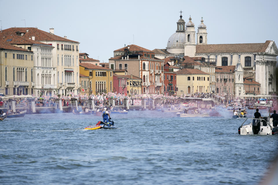 FILE - In this June 5, 2021 file photo, "No Big Ships" activists stage a protest as the MSC Orchestra cruise ship leaves Venice, Italy. UNESCO’s World Heritage Committee is debating Thursday, July 22, 2021, whether Venice and its lagoon environment will be designated a world heritage site in danger due to the impact of over-tourism alongside the steady decline in population and poor governance. (AP Photo/Antonio Calanni, file)