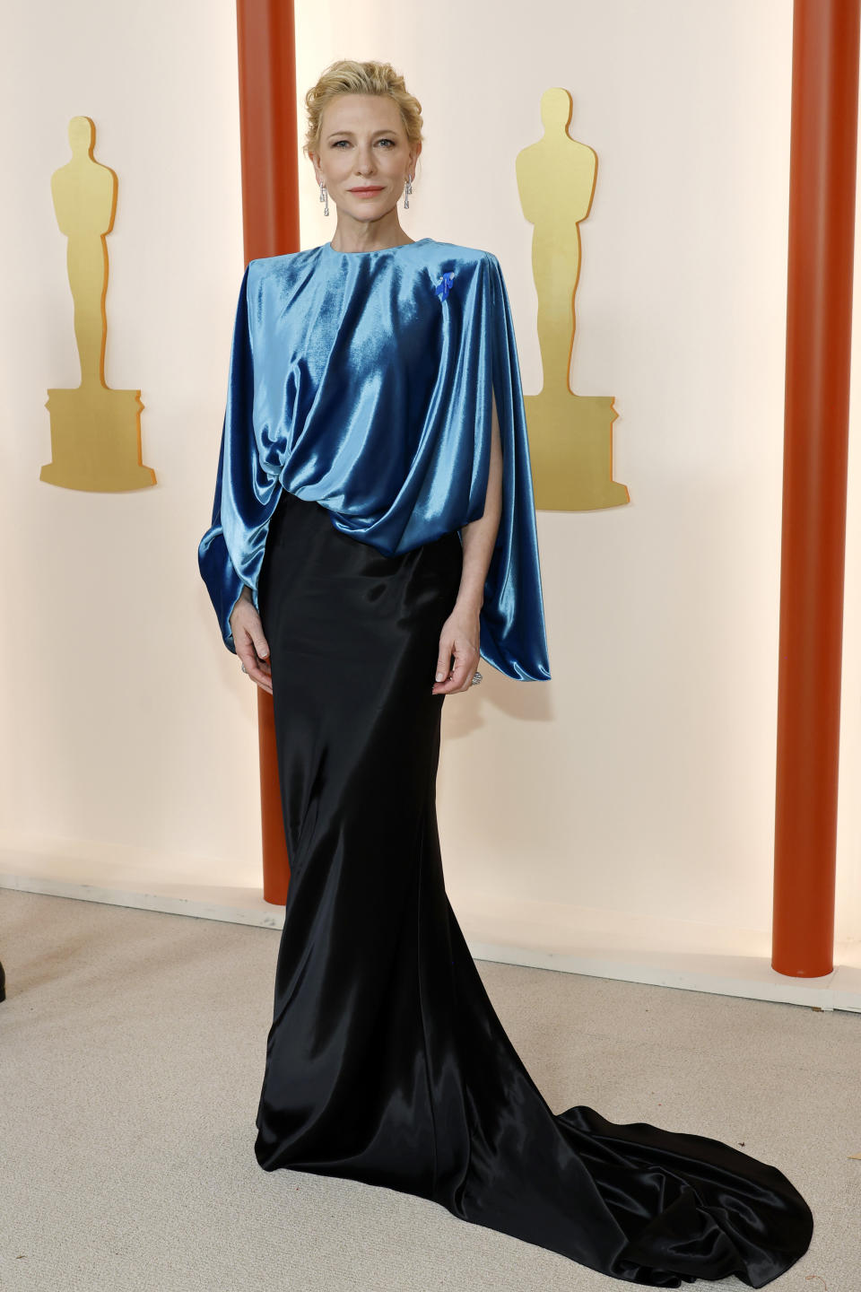 Cate in a satiny gown with a train