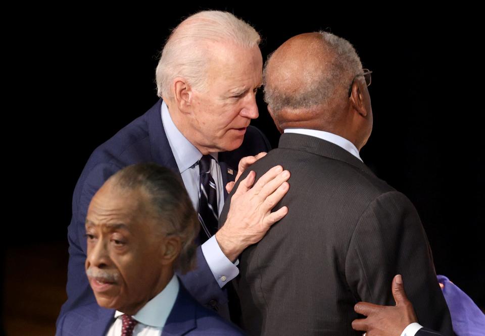 Former Vice President Joe Biden speaks with Rep. James Clyburn, D-S.C., at right, at the Ministers Breakfast hosted by National Action Network and Rev. Al Sharpton, at left, on Feb. 26, 2020 in North Charleston, South Carolina.