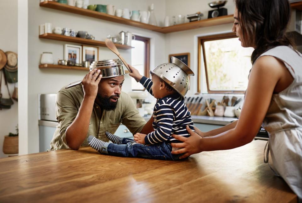 shot of an adorable young family having fun with pots and pans in the kitchen