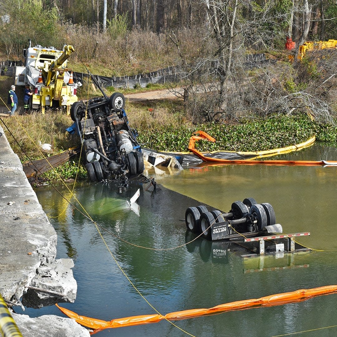Chancey's Towing Service and Wayne's Towing work to remove an 18-wheeler on December 27, 2021, that had crashed into the Augusta Canal from the I-20 bridge the previous night.