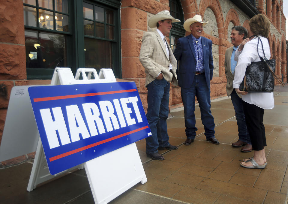 From left, Lane Hageman, Jim Hageman, Vic and Jane Garber share a laugh during Republican Harriet Hageman's gubernatorial watch party on Tuesday, Aug. 21, 2018, at the Cheyenne Depot Museum in Cheyenne, Wyo. (Blaine McCartney/The Wyoming Tribune Eagle via AP)