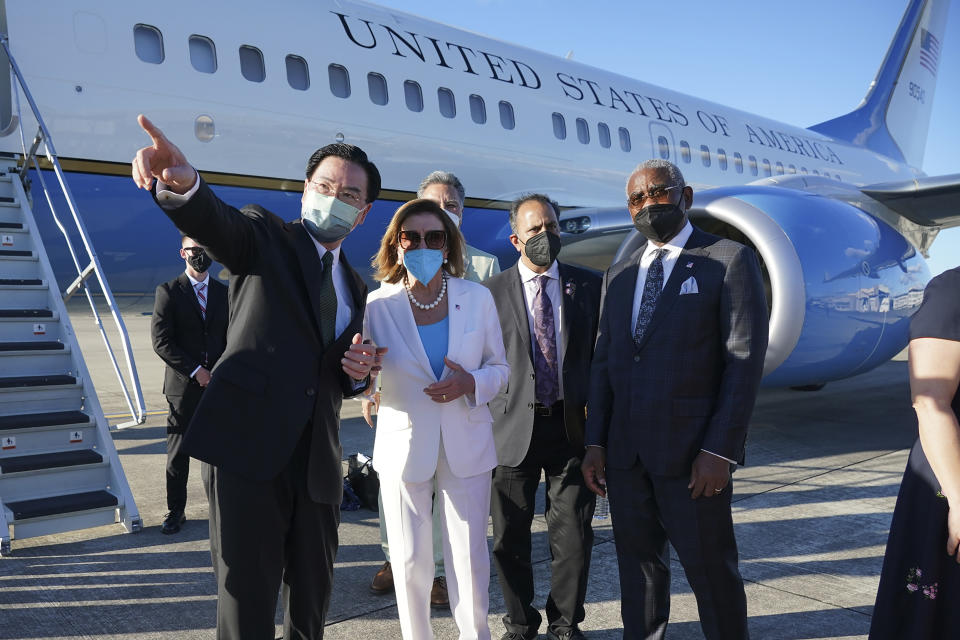 FILE - In this photo released by Taiwan's Ministry of Foreign Affairs, Taiwan's Foreign Minister Joseph Wu, left, gestures while speaking with U.S. House Speaker Nancy Pelosi as she prepares to leave Taipei, Taiwan, Aug. 3, 2022. While inflation and recession fears weigh heavily on the minds of voters, another issue is popping up in political campaigns from the U.K. and Australia to the U.S. and beyond: the “China threat." The two finalists vying to become Britain's next prime minister, Liz Truss and Rishi Sunak, clashed in a televised debate last month over who would be toughest on China. (Taiwan Ministry of Foreign Affairs via AP, File)