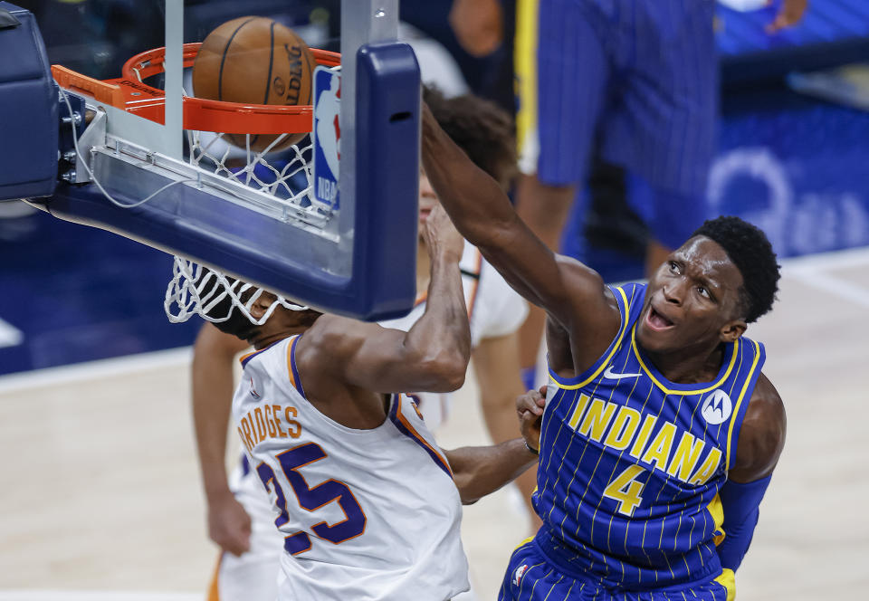 Victor Oladipo goes up for the dunk against Mikal Bridges of the Phoenix Suns.