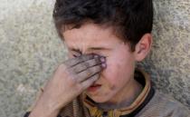 A displaced Iraqi boy who was among rescued at the site of battle rests at the positions of Iraqi forces at the Old City in Mosul, Iraq June 29, 2017. REUTERS/Erik De Castro