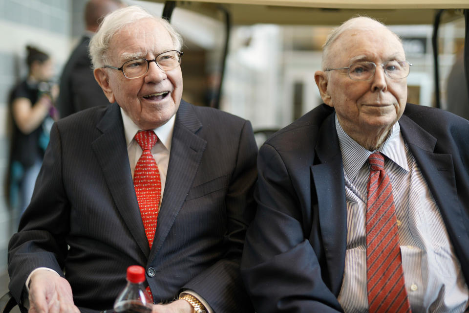 In this May 3, 2019 file photo, Berkshire Hathaway Chairman and CEO Warren Buffett, left, and Vice Chairman Charlie Munger, briefly chat with reporters before Berkshire Hathaway's annual shareholders meeting. (AP Photo/Nati Harnik)