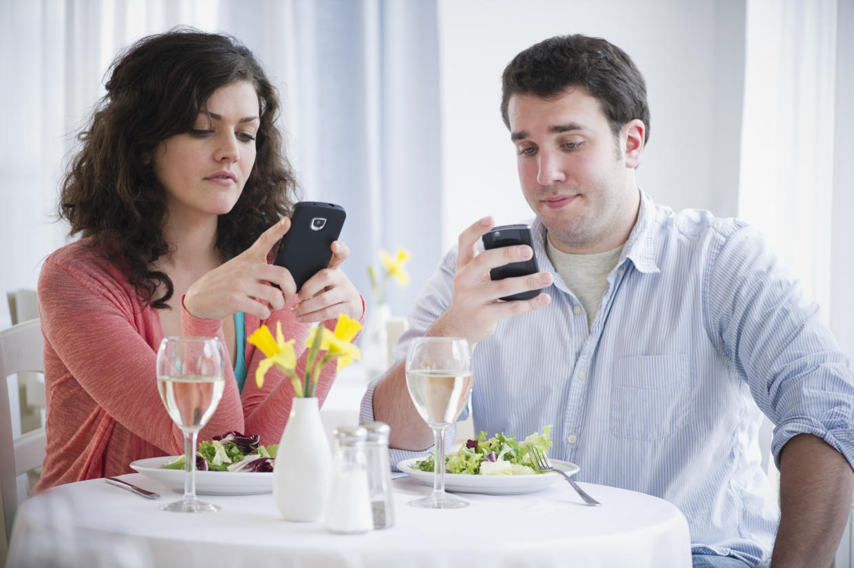 <em>Four in ten Brits don’t think it’s socially acceptable to use your mobile phone whilst out for a meal at a restaurant with friends (Picture: Getty)</em>