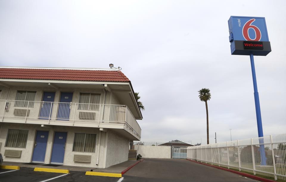 FILE - This Jan. 29, 2019, file photo, shows a Motel 6 in Phoenix. A revised settlement for Motel 6 guests who say the national chain invaded their privacy by giving their information to immigration authorities is returning to court for a judge's review. A federal judge is to decide Friday, July 19, 2019, on the proposal increasing to $10 million the total amount available for claims. (AP Photo/Ross D. Franklin, File)