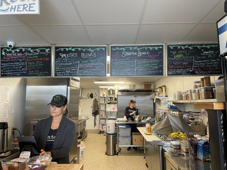 Tanya Fransen works at the register of her cafe, Plantonic, in Hartford. The cafe features a menu of organic, dairy- and gluten-free items.