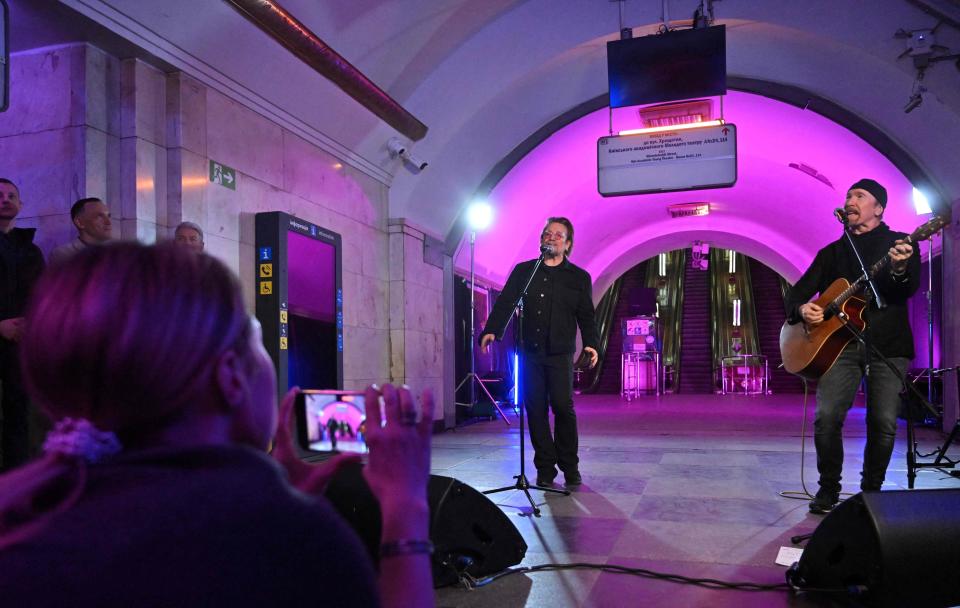 Bono and the Edge perform at a subway station used as a a bomb shelter, in the center of Ukrainian capital of Kyiv on May 8, 2022.