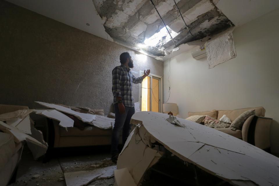 Mohamed Fahim inspects his house that was damaged by an intercepted missile in the aftermath of what Saudi-led coalition said was a thwarted Houthi missile attack, in Riyadh, Saudi Arabia, February 28, 2021 (Ahmed Yosri / Reuters)